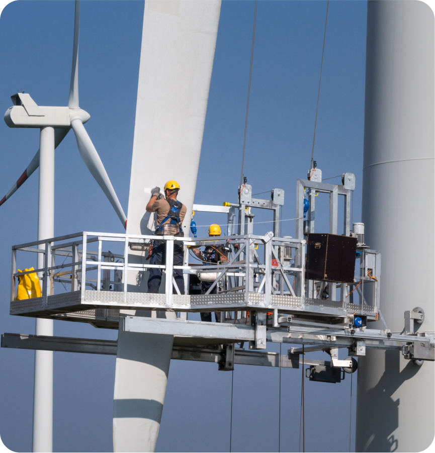 Man in hard hat fixing wind turbine